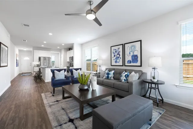 a living room with furniture and wooden floor