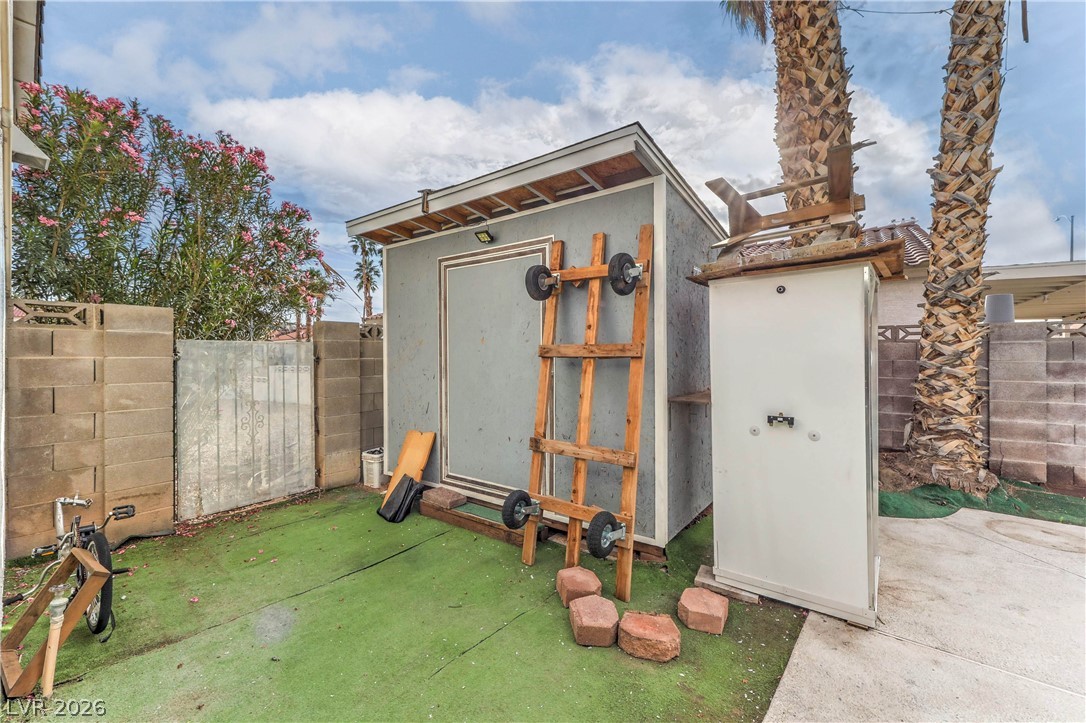 581 Carleton Drive Henderson, NV 89014 - Photo 28 of 37 A quaint backyard shed provides practical storage solutions for outdoor essentials.