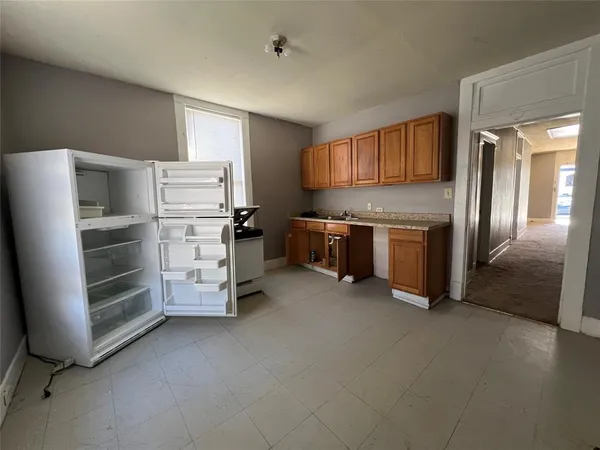 a kitchen with stainless steel appliances a refrigerator and a stove
