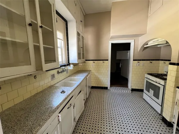 a kitchen with a sink stove and refrigerator