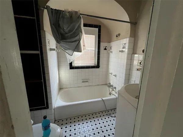 a bathroom with a bathtub and a shower