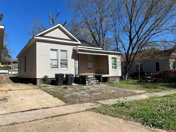 a front view of a house with a yard outdoor seating and barbeque oven