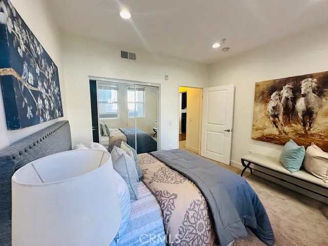 a bedroom with bed couch and window