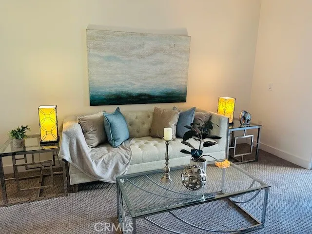 a living room with furniture and a table with wooden floor