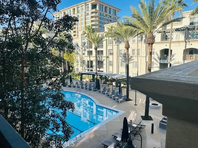 a view of a swimming pool with outdoor seating and plants