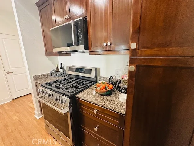 a kitchen with stainless steel appliances granite countertop a stove and a microwave
