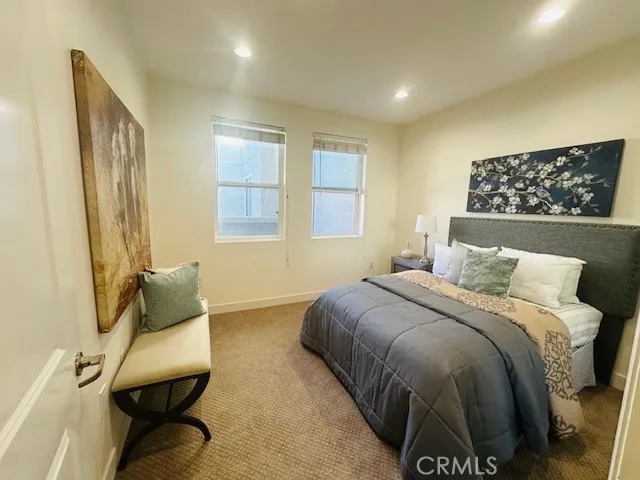 a bedroom with a bed and a chair