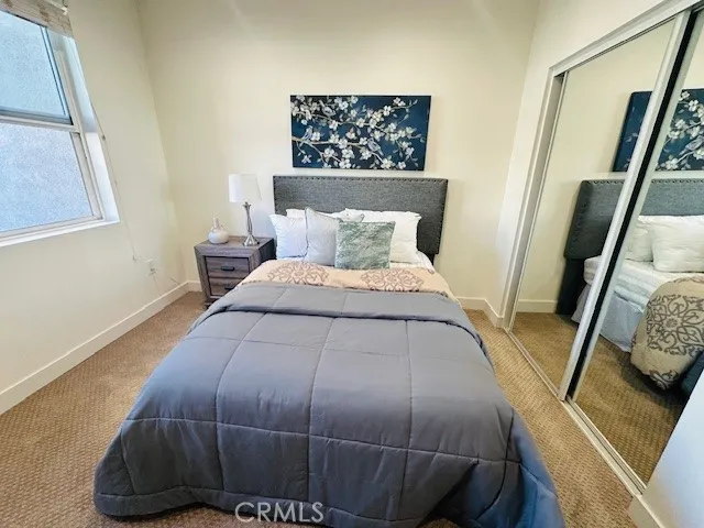 a bed sitting in a bedroom next to a window