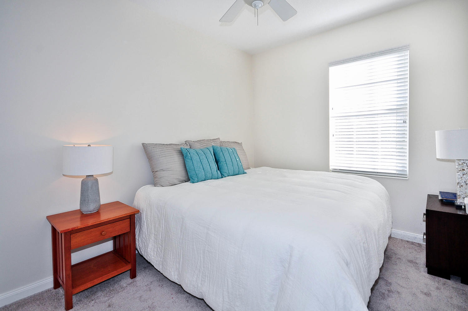 4135 Community Drive Jupiter, FL 33458 - Photo 26 of 39 a bedroom with a bed and a lamp