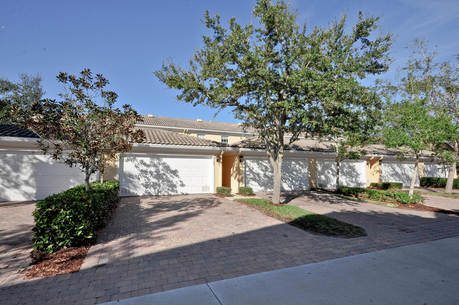 4135 Community Drive Jupiter, FL 33458 - Photo 31 of 39 a front view of a house with a yard and garage