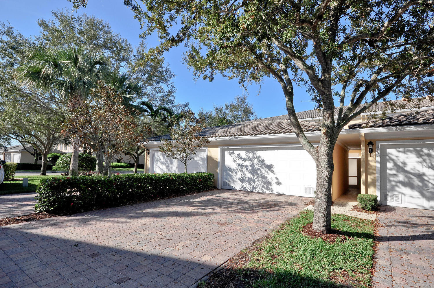 4135 Community Drive Jupiter, FL 33458 - Photo 32 of 39 a front view of a house with garden