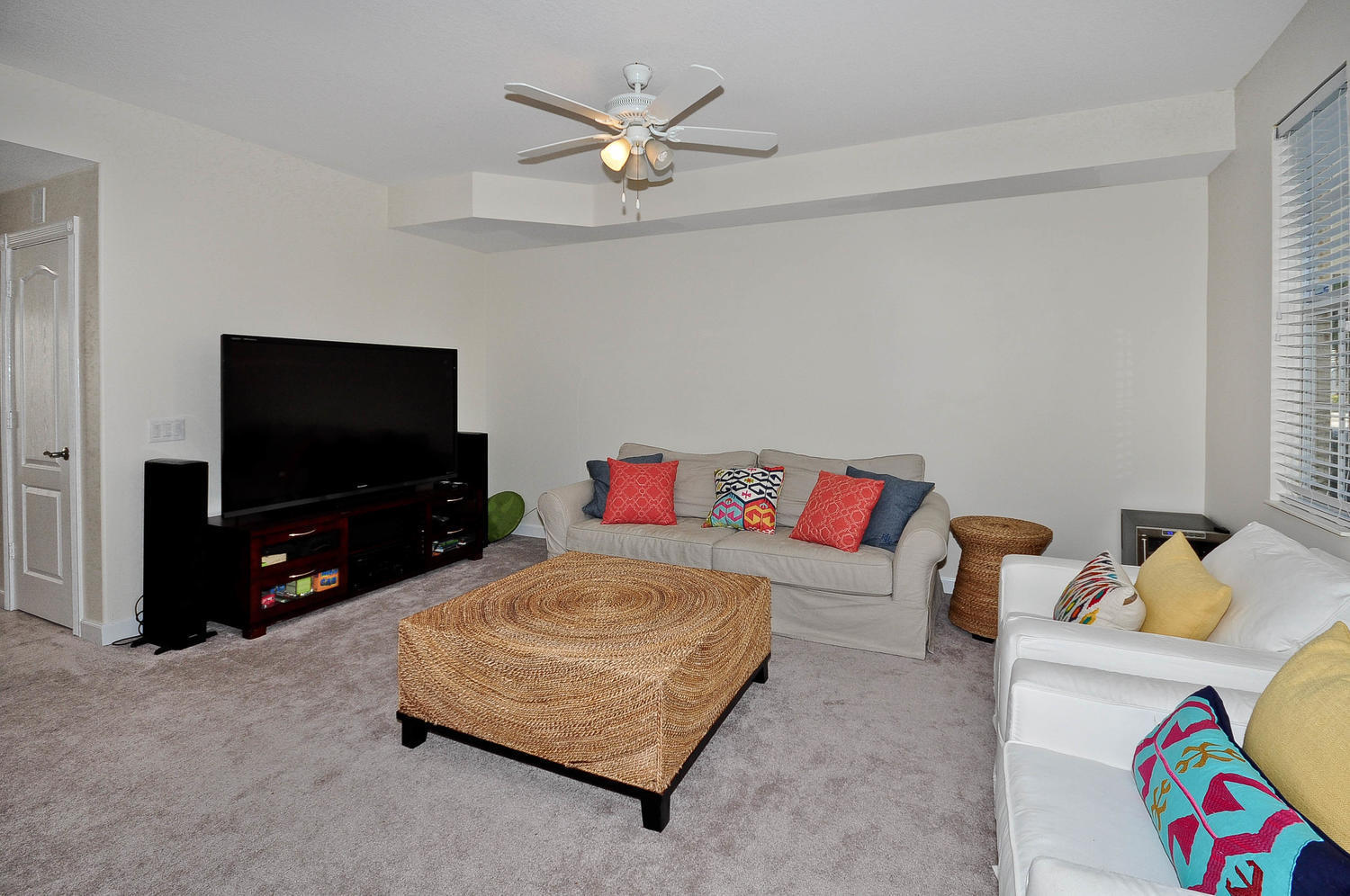 4135 Community Drive Jupiter, FL 33458 - Photo 4 of 39 a living room with furniture and a flat screen tv