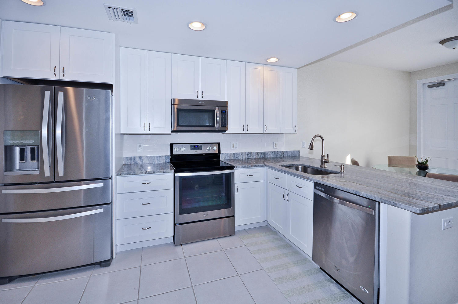 4135 Community Drive Jupiter, FL 33458 - Photo 7 of 39 a kitchen with a sink appliances and cabinets