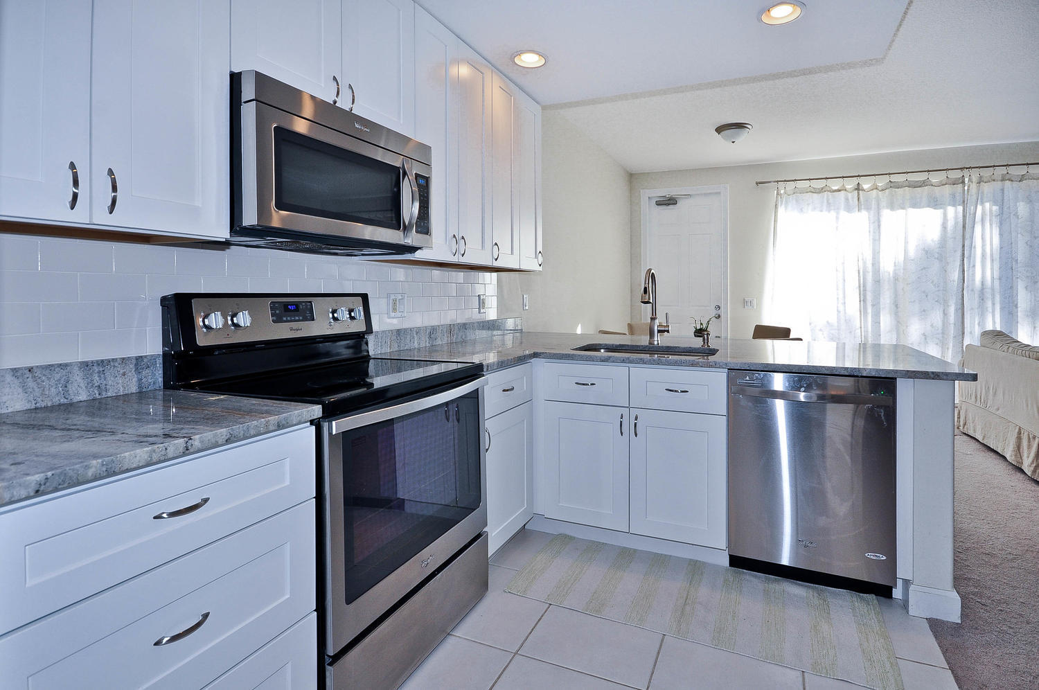 4135 Community Drive Jupiter, FL 33458 - Photo 8 of 39 a kitchen with a sink stove and microwave
