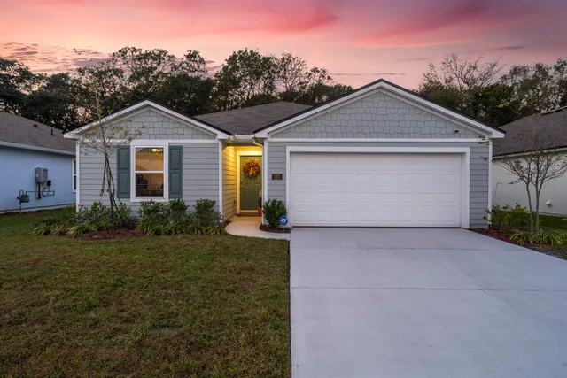 a front view of a house with garden