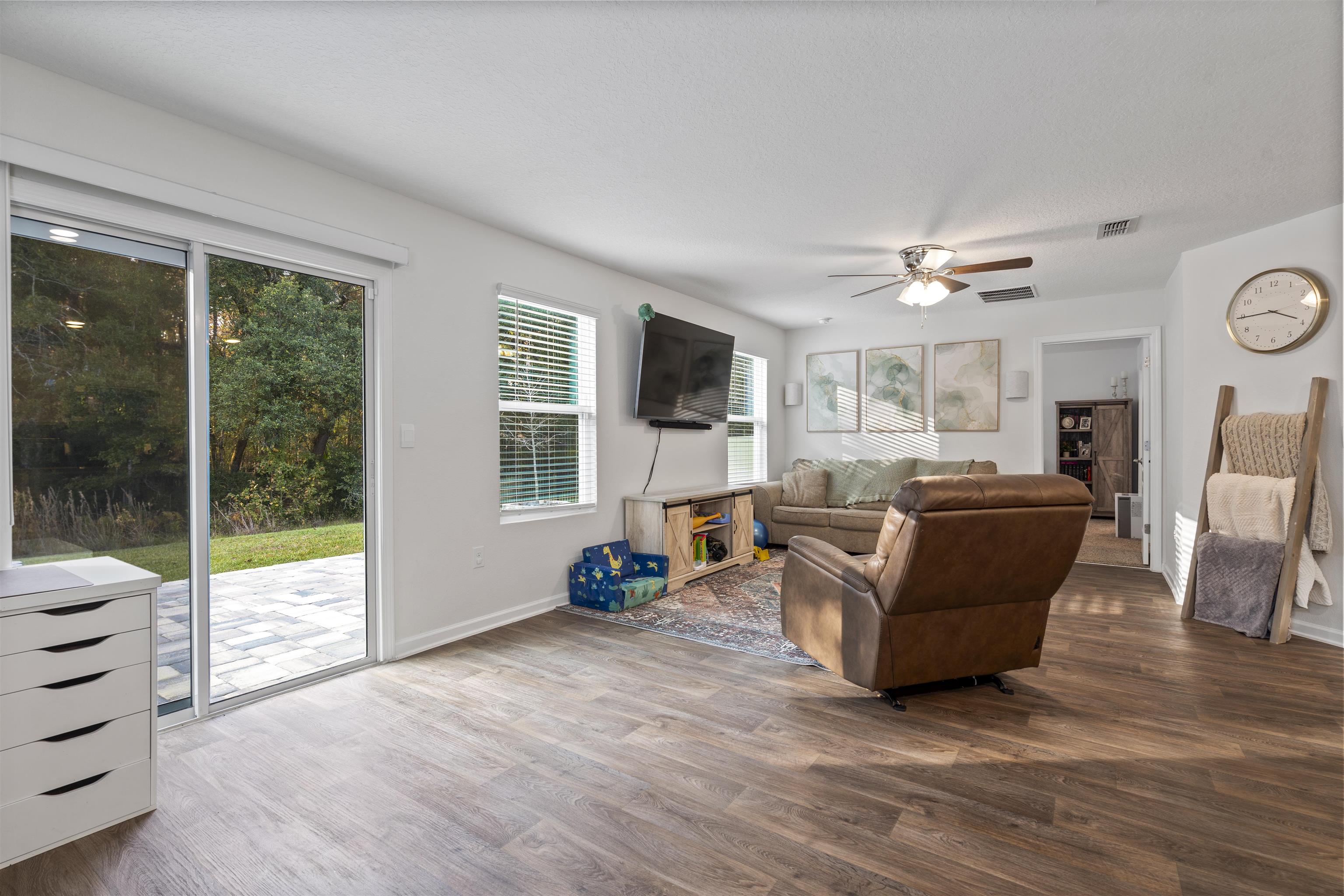 127 Encanto Way St. Augustine, FL 32084 - Photo 11 of 43 a living room with furniture a fireplace and a flat screen tv