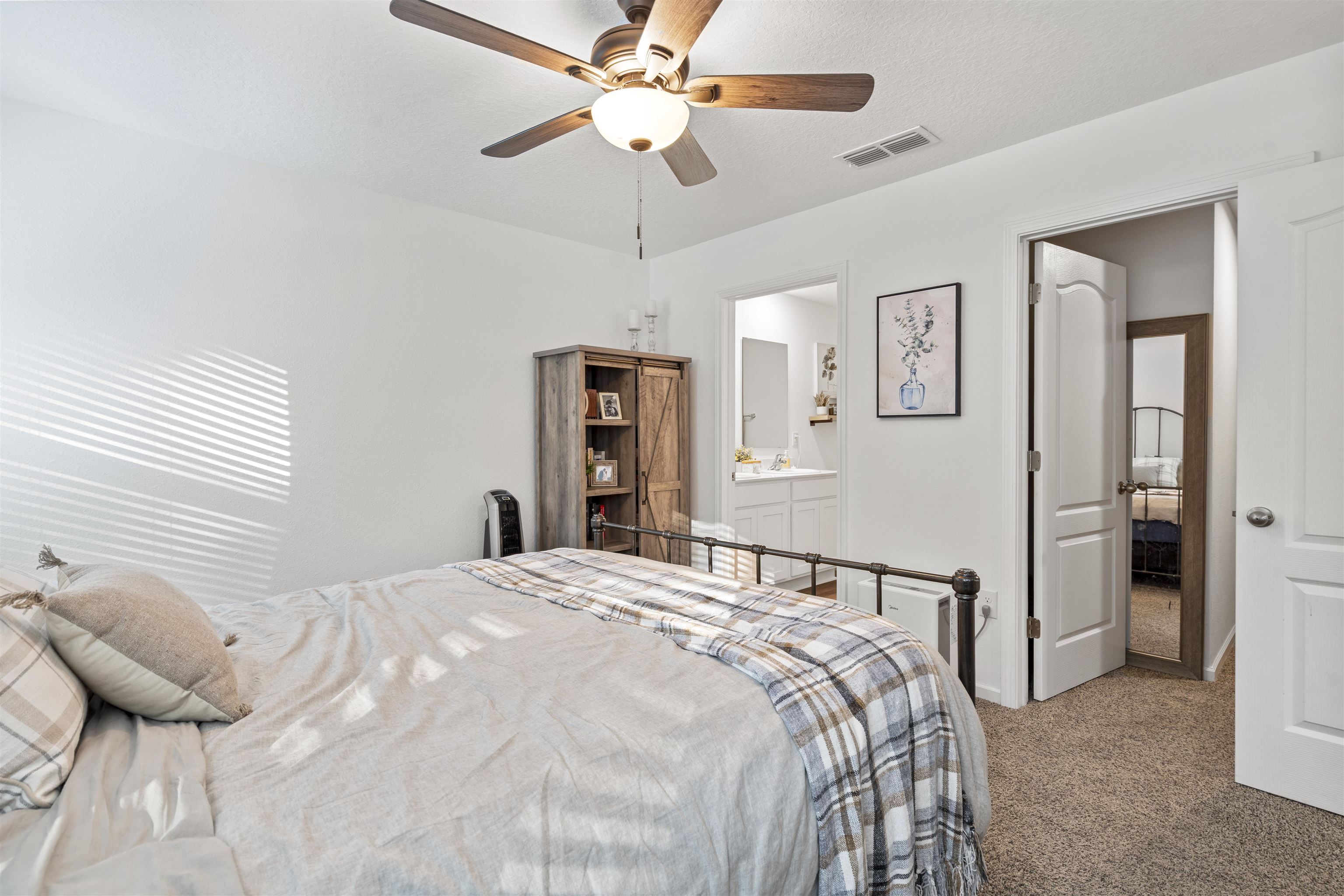 127 Encanto Way St. Augustine, FL 32084 - Photo 16 of 43 a bedroom with a bed and a chandelier