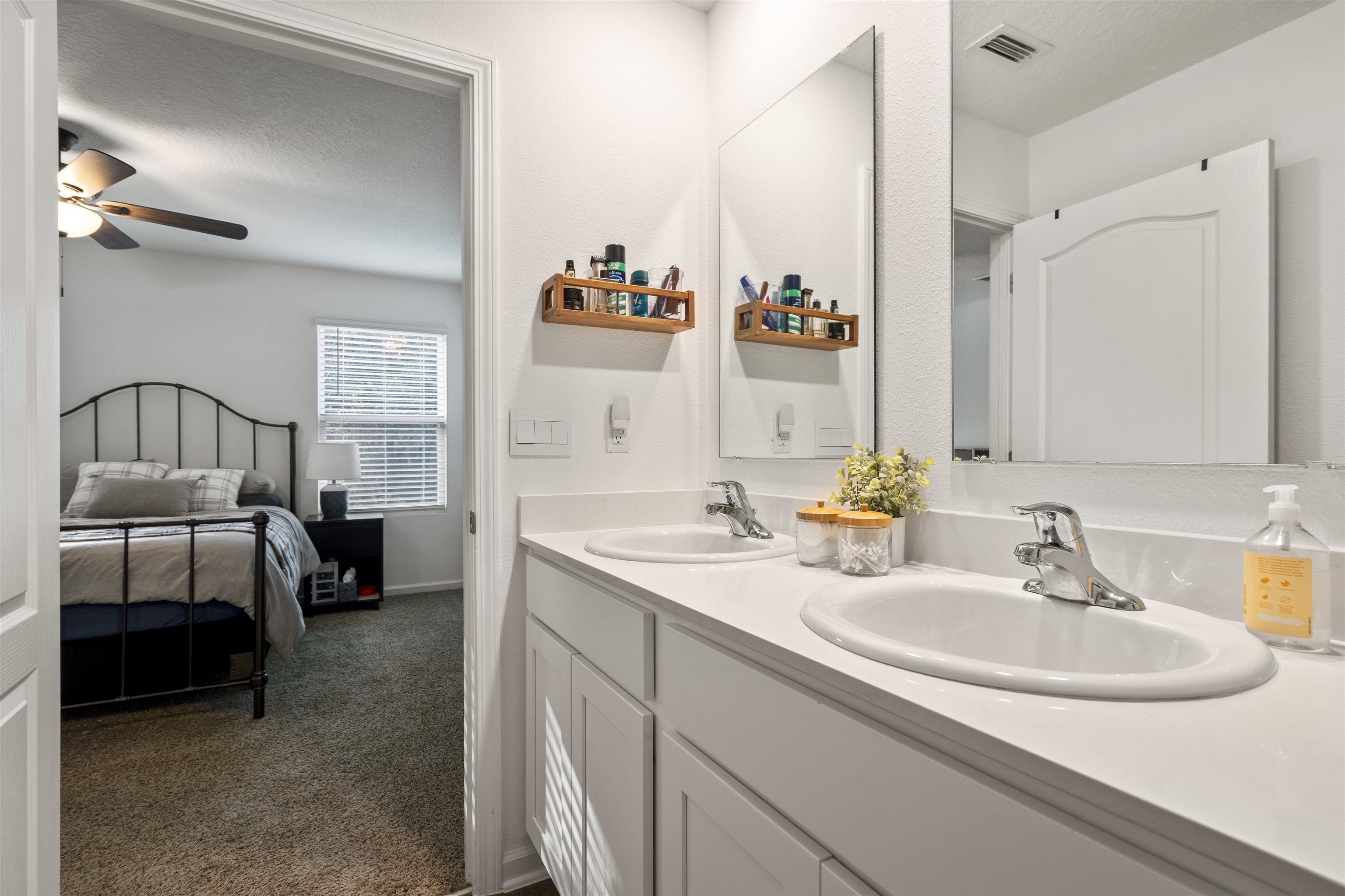 127 Encanto Way St. Augustine, FL 32084 - Photo 18 of 43 a en suite bathroom with a double vanity sink and a mirror