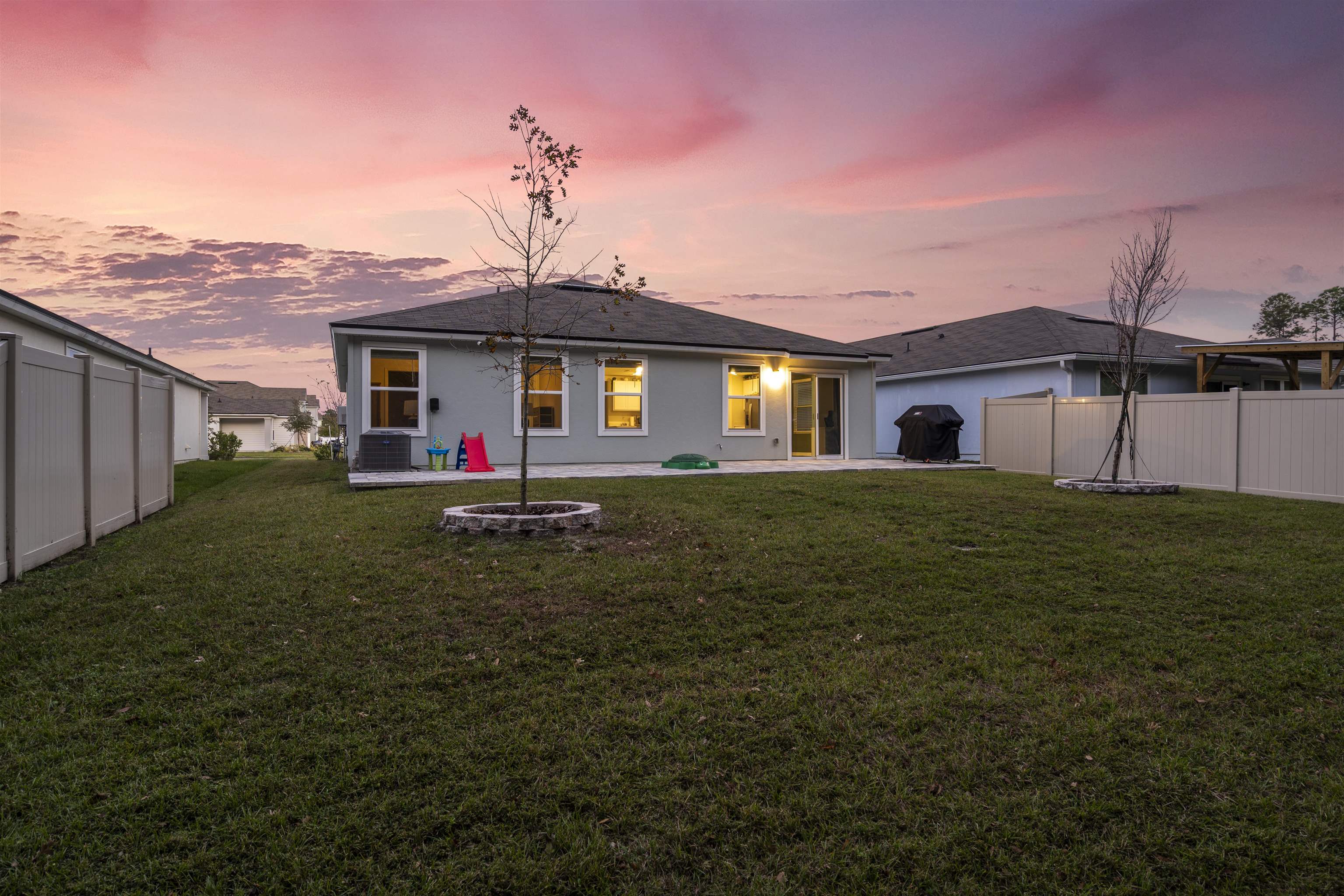 127 Encanto Way St. Augustine, FL 32084 - Photo 30 of 43 a view of a white house next to a yard with big trees