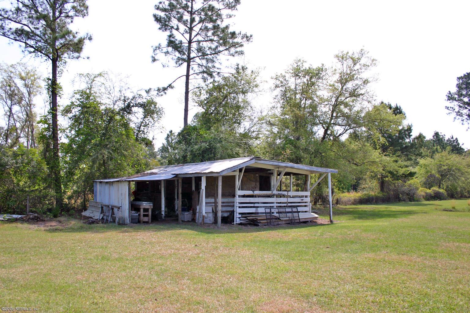 16231 Shark Road West Jacksonville, FL 32226 - Photo 4 of 10 a front view of house with yard and trees in the background