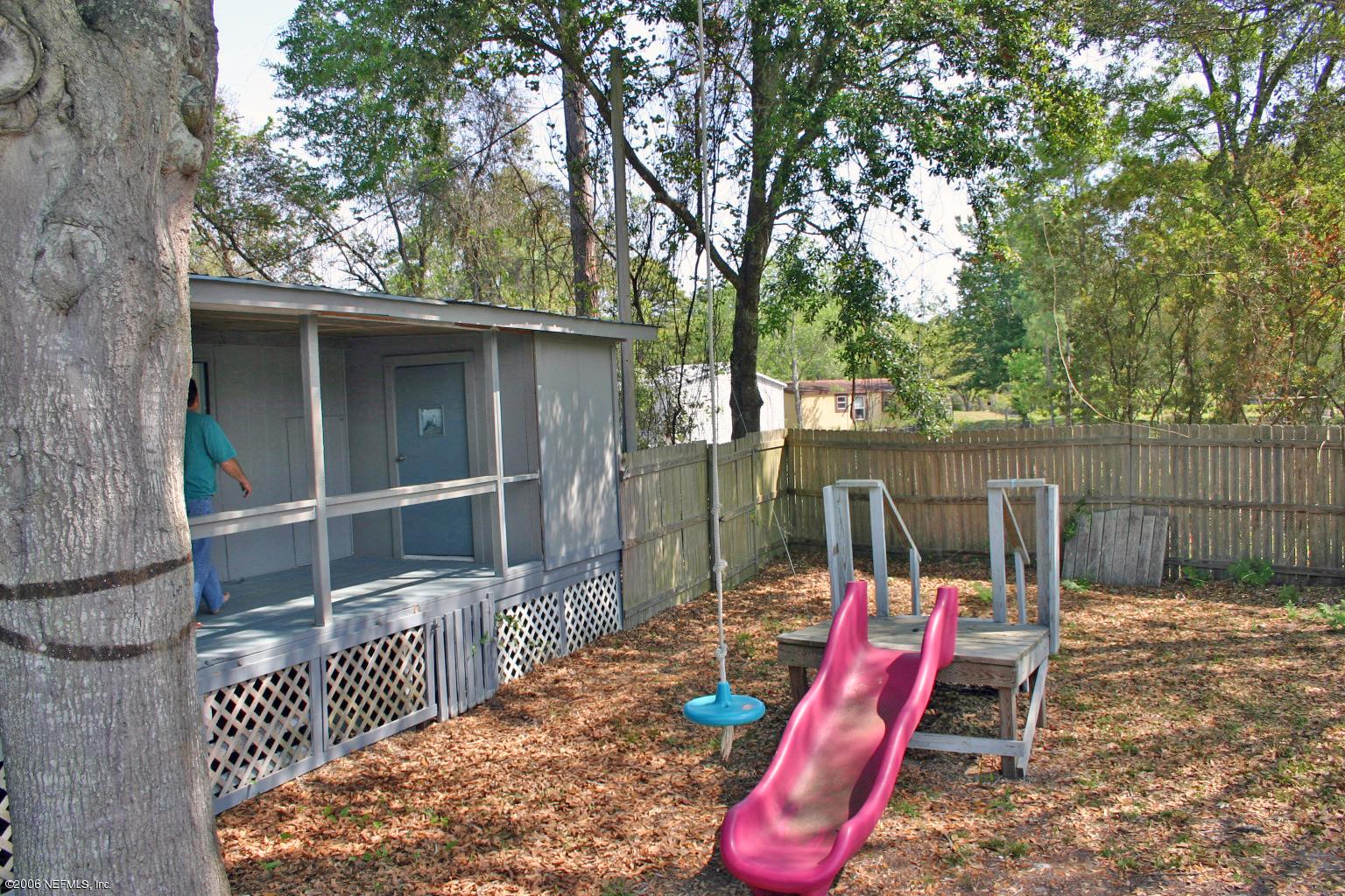 16231 Shark Road West Jacksonville, FL 32226 - Photo 7 of 10 a backyard of a house with entertaining space and iron fence