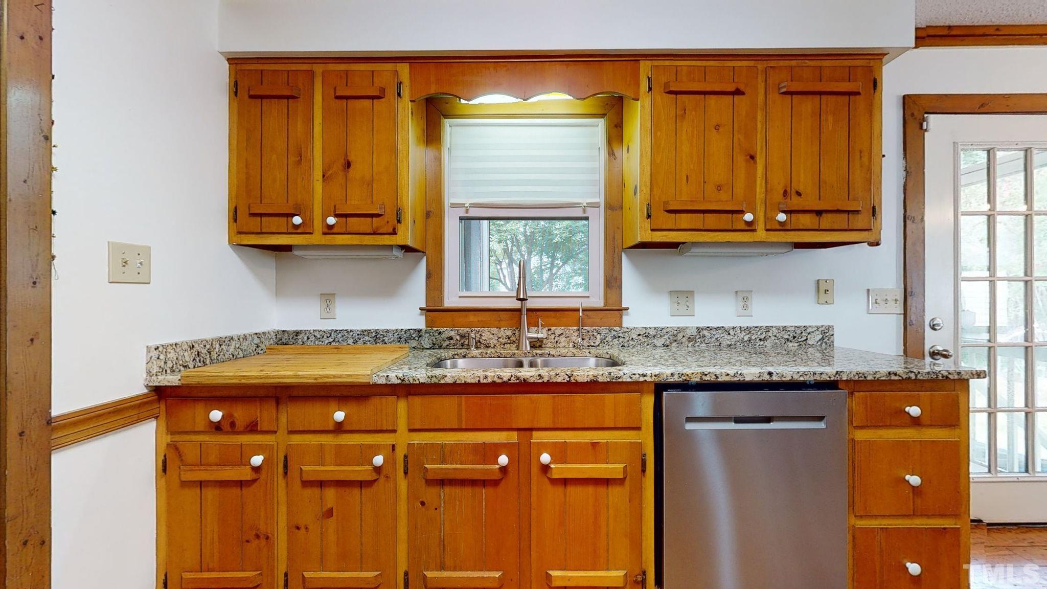 3308 Gatcombe Place Raleigh, NC 27604 - Photo 14 of 43 a kitchen with granite countertop cabinets and window