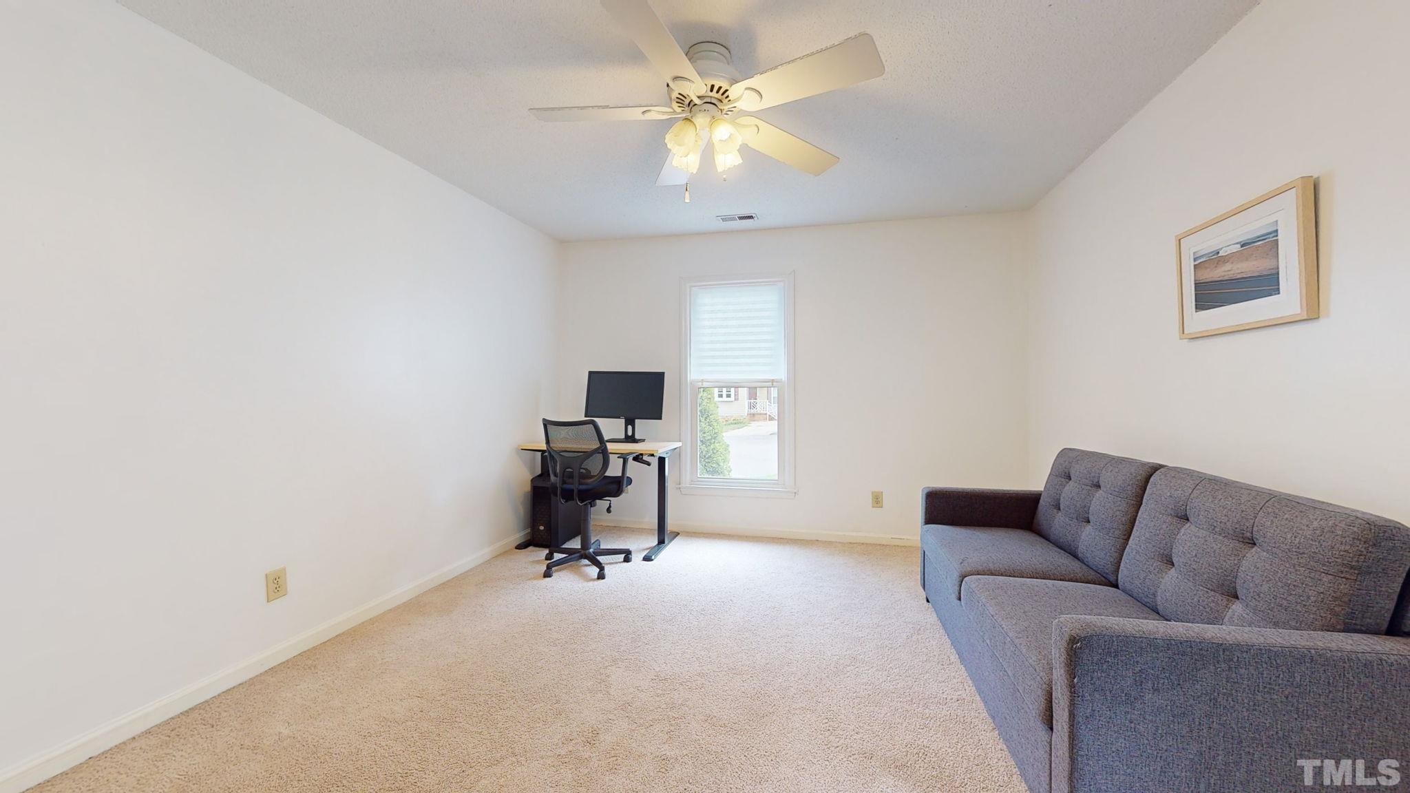 3308 Gatcombe Place Raleigh, NC 27604 - Photo 19 of 43 a livingroom with a couch and a ceiling fan
