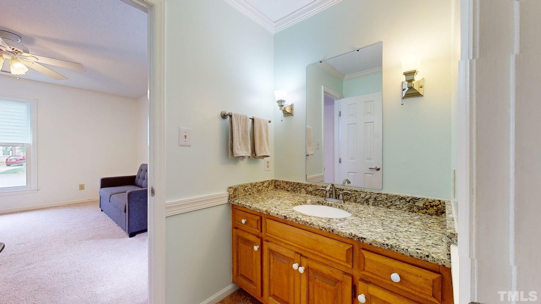 3308 Gatcombe Place Raleigh, NC 27604 - Photo 20 of 43 a bathroom with a granite countertop sink and a mirror