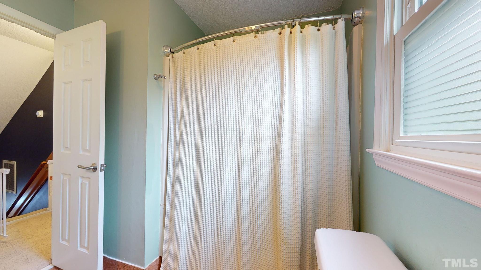 3308 Gatcombe Place Raleigh, NC 27604 - Photo 25 of 43 a bathroom with a shower curtain and a curtain