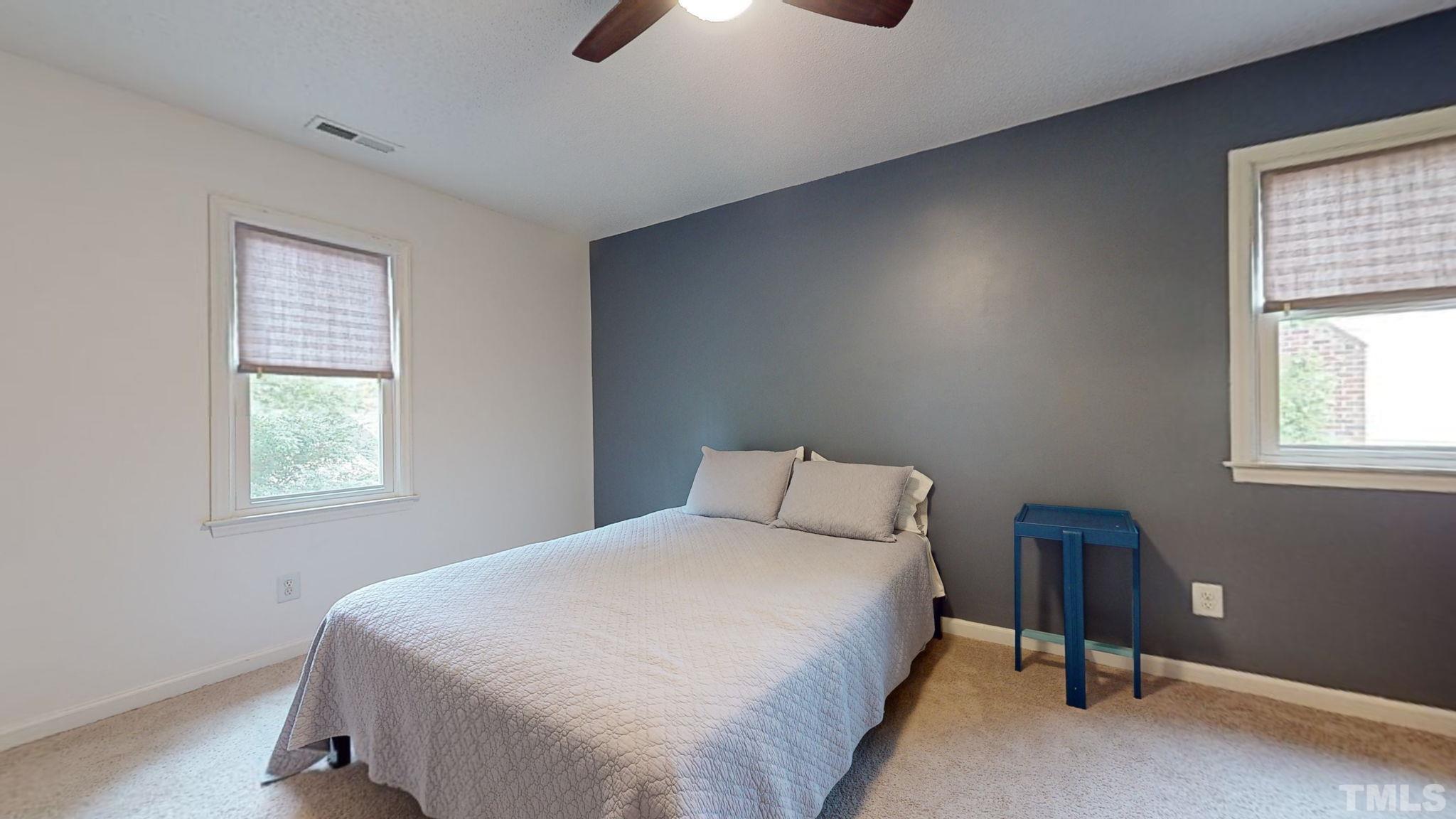 3308 Gatcombe Place Raleigh, NC 27604 - Photo 26 of 43 a bedroom with a bed and a chandelier