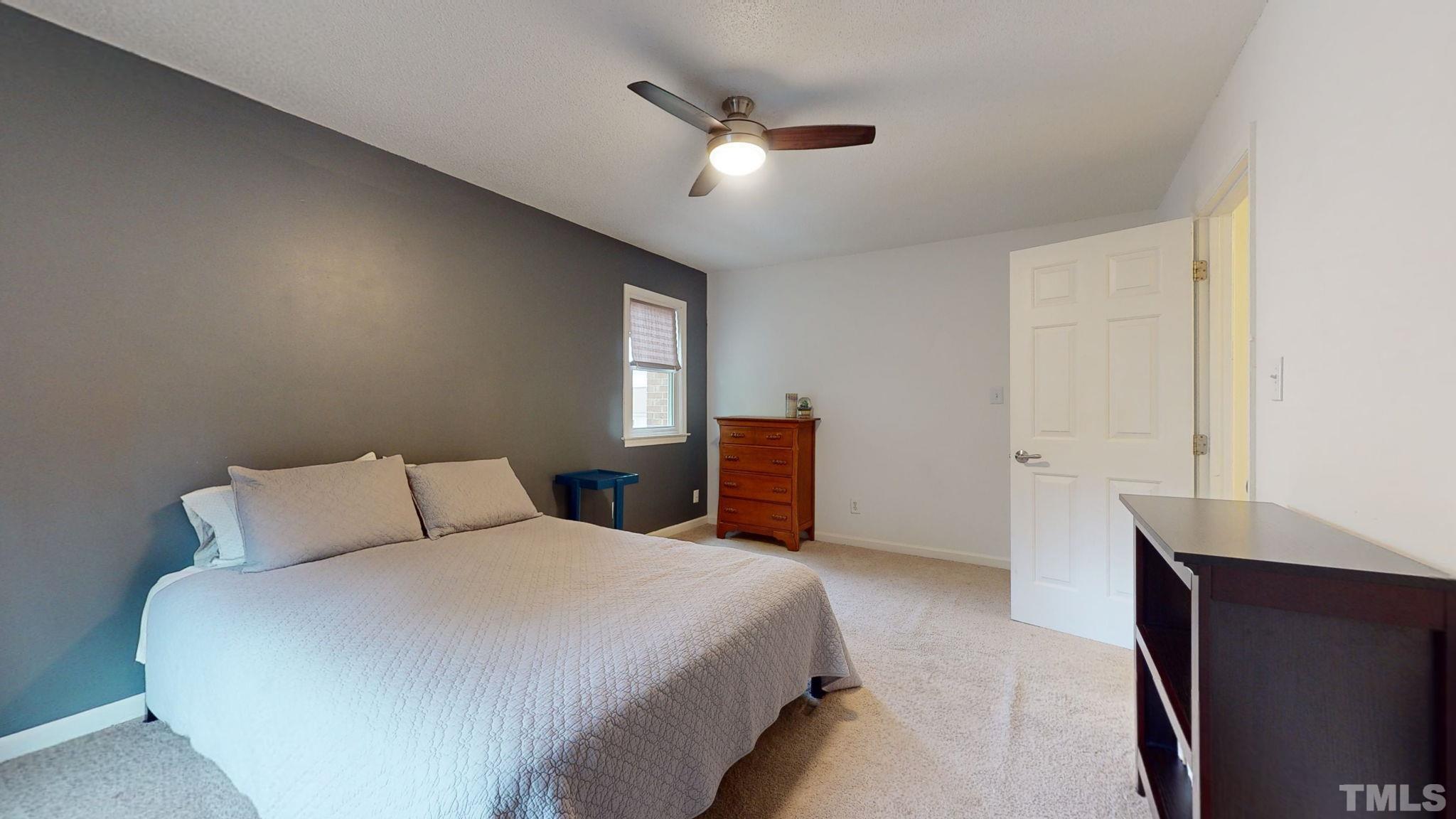 3308 Gatcombe Place Raleigh, NC 27604 - Photo 27 of 43 a bedroom with a bed and a chandelier