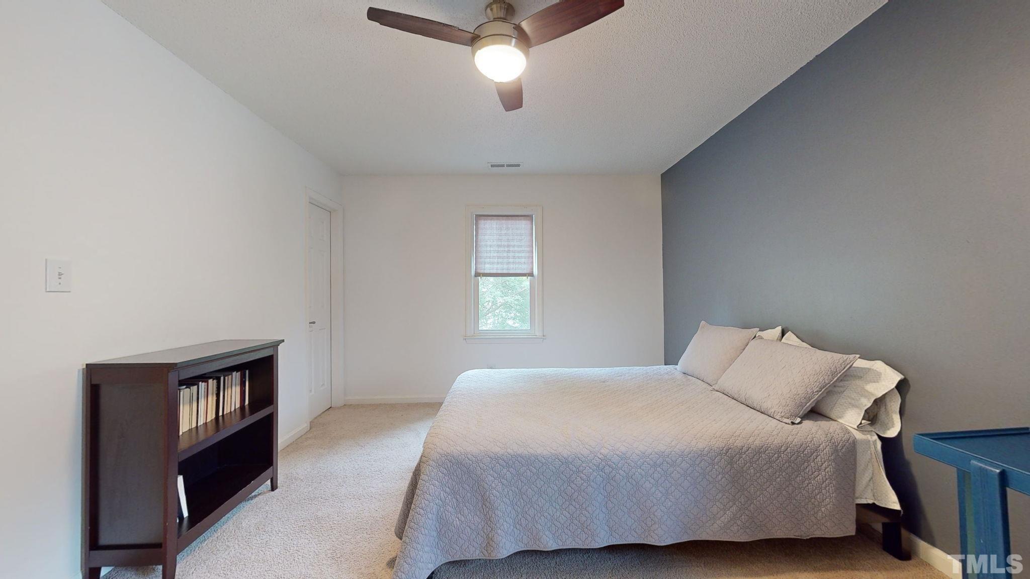 3308 Gatcombe Place Raleigh, NC 27604 - Photo 28 of 43 a bedroom with a bed and a night stand