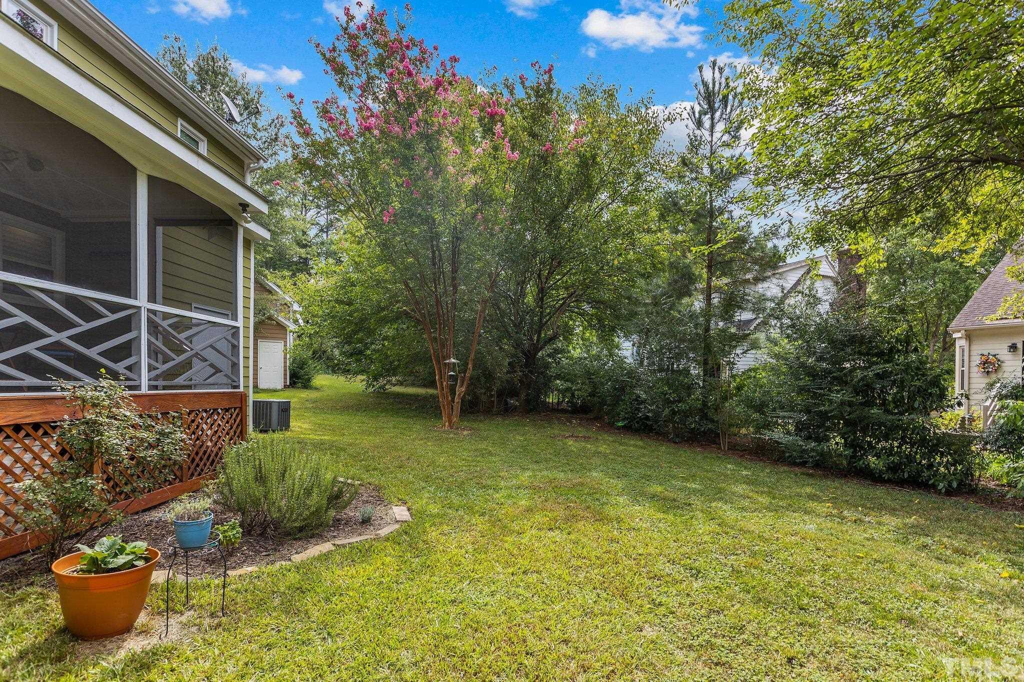 3308 Gatcombe Place Raleigh, NC 27604 - Photo 40 of 43 a view of a backyard with plants and a bench