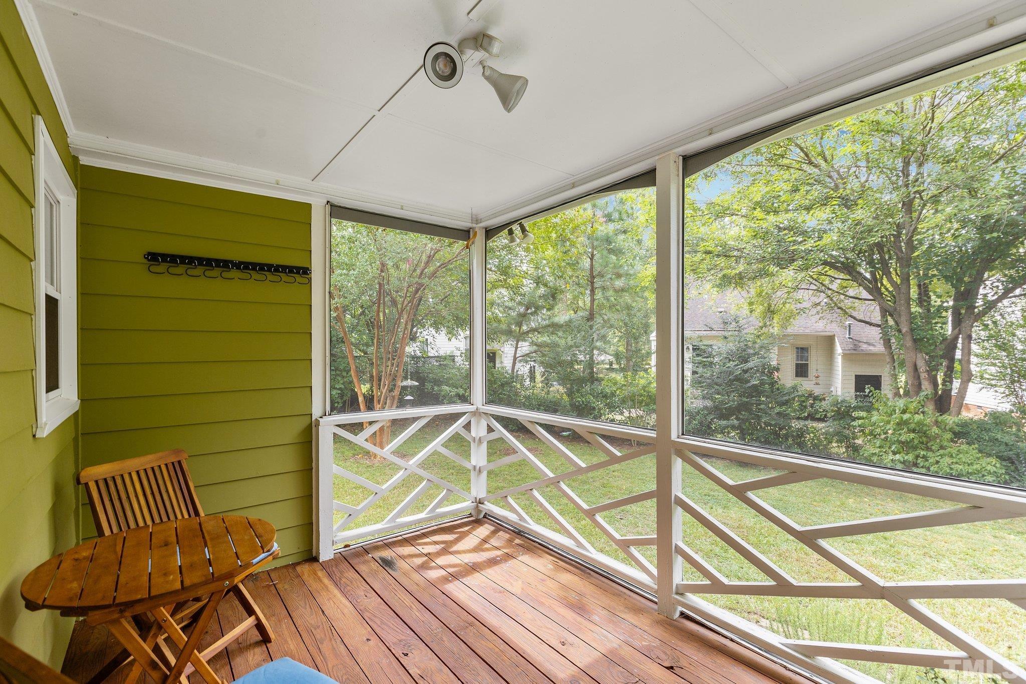 3308 Gatcombe Place Raleigh, NC 27604 - Photo 42 of 43 a view of a balcony with chair and floor to ceiling windows