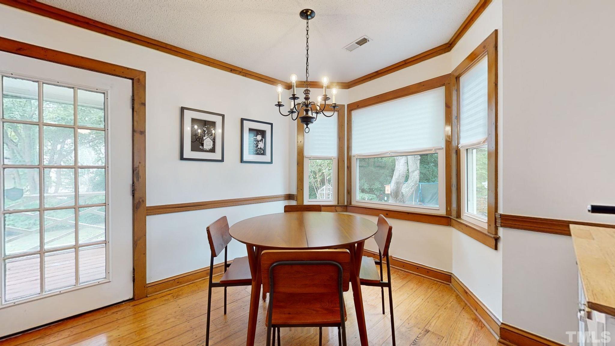 3308 Gatcombe Place Raleigh, NC 27604 - Photo 10 of 43 a dining room with furniture a chandelier and wooden floor