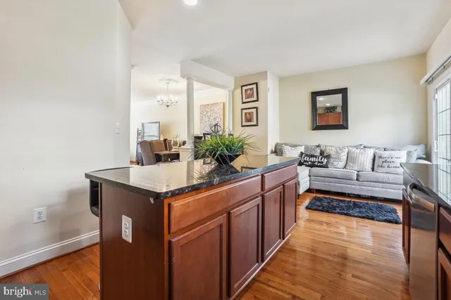 a kitchen with stainless steel appliances granite countertop a sink and a stove