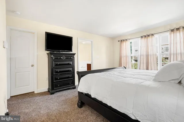 a bedroom with a bed and a television