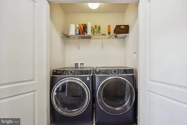 a view of storage and utility room with washer and dryer