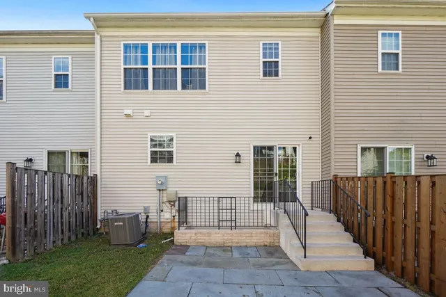 a view of a house with wooden fence