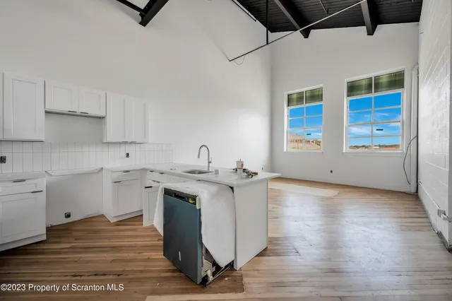 a kitchen with a sink cabinets and window