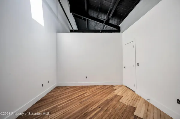 a view of a room with wooden floor