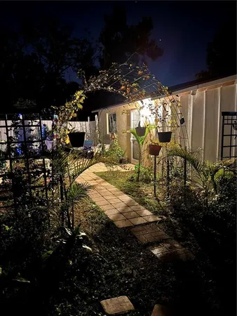 a view of a porch with chairs and potted plants