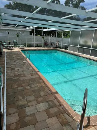 a view of a backyard with table and chairs a barbeque