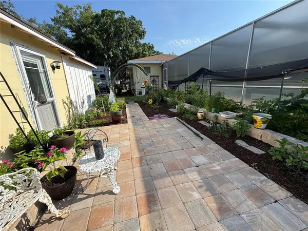 a view of a backyard with sitting area