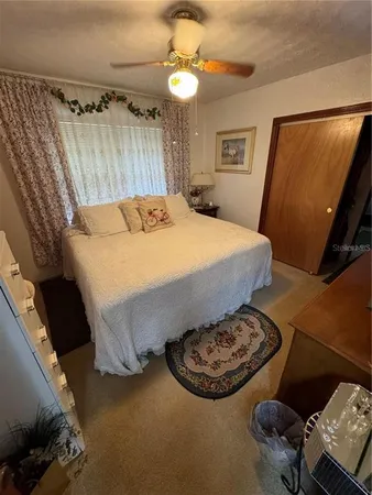 a bed sitting in a bedroom next to a window