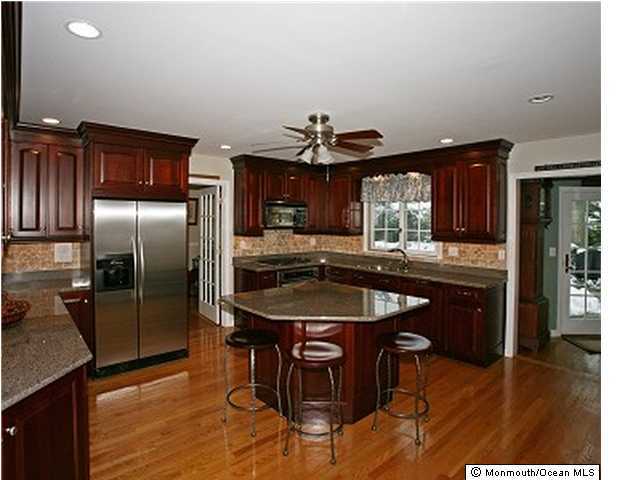 8 Blossom Road Rumson, NJ 07760 - Photo 2 of 3 a kitchen with stainless steel appliances granite countertop a sink a stove and a refrigerator