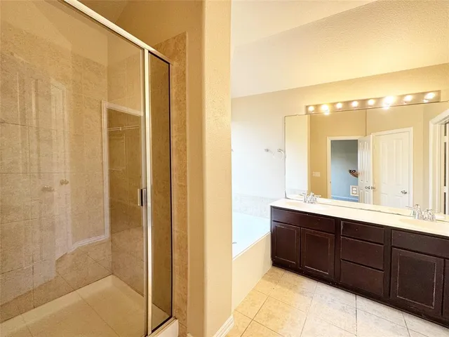 a bathroom with a double vanity sink a mirror and a shower