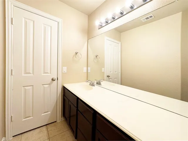a bathroom with a double vanity sink and a mirror