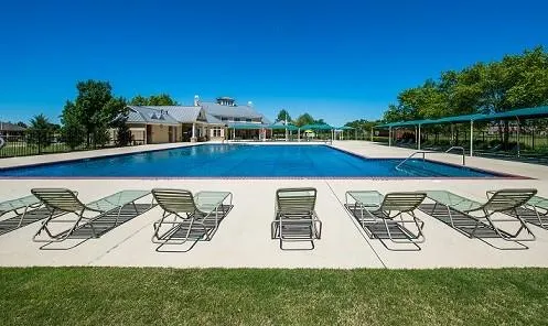 a view of swimming pool with outdoor seating and plants