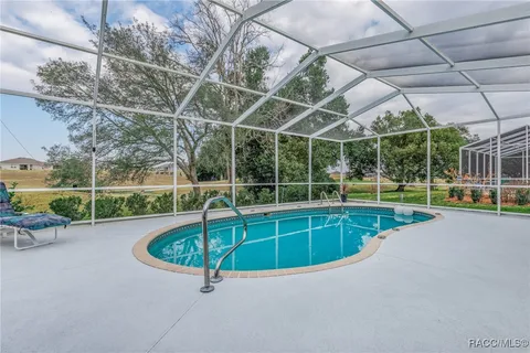 a view of a backyard with swimming pool